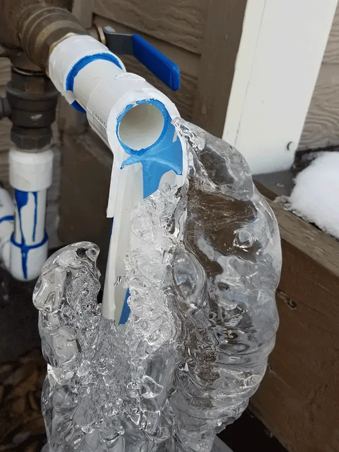 Frozen pipe split behind a garage wall in Big Lake, MN